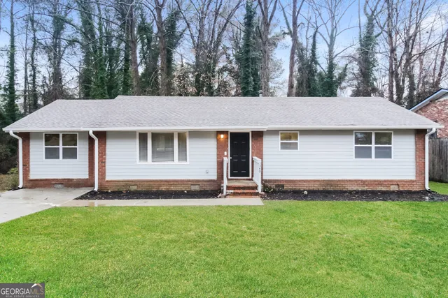 a front view of a house with a garden