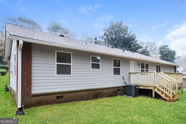 a view of a house with a yard and sitting area