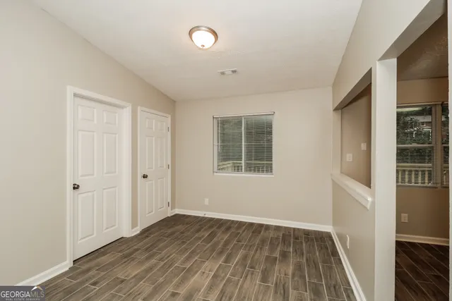 a view of a room with wooden floor and windows