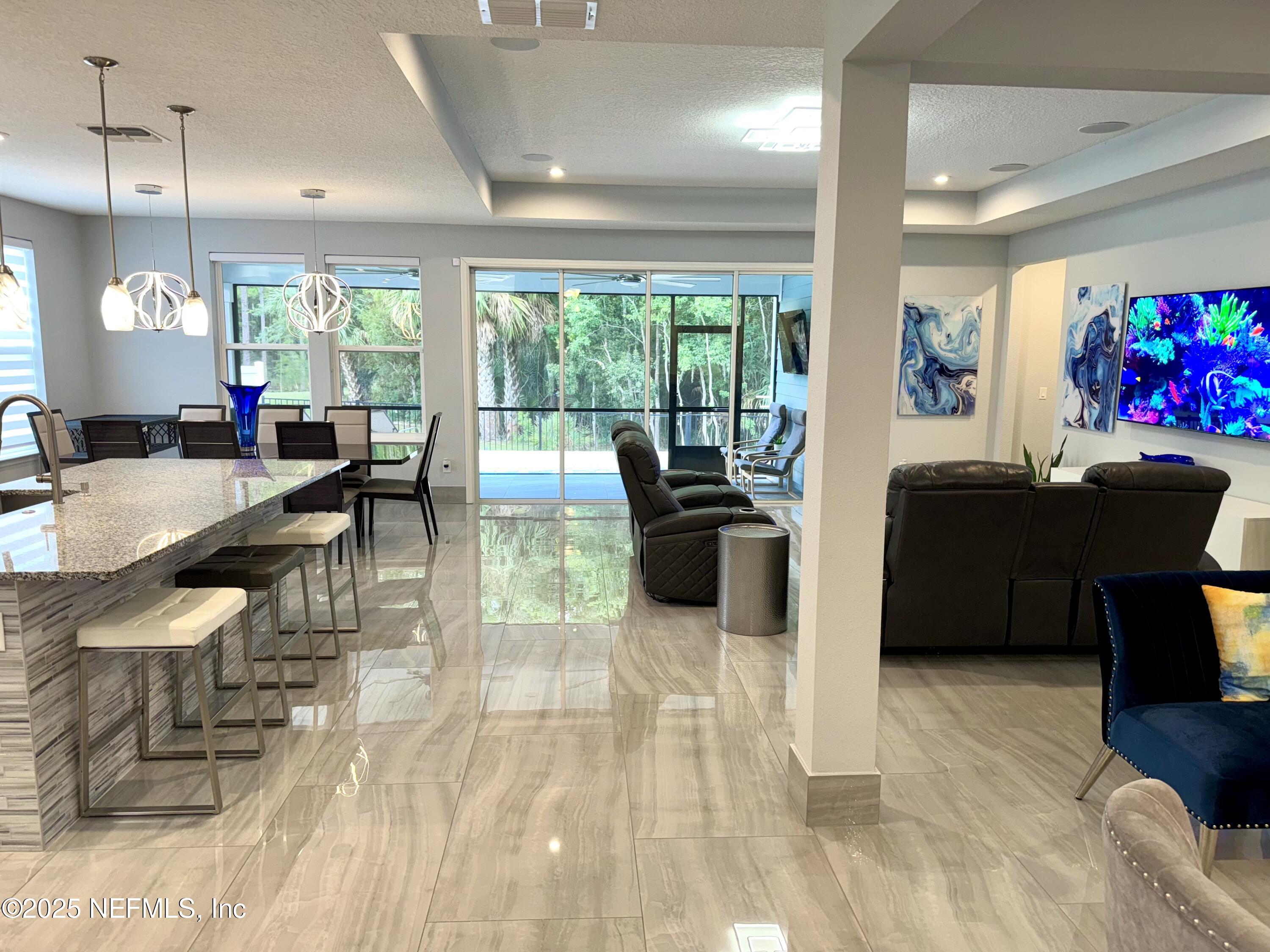 163 Pine Forest Court St. Augustine, FL 32092 - Photo 22 of 85 a living room with furniture and a flat screen tv