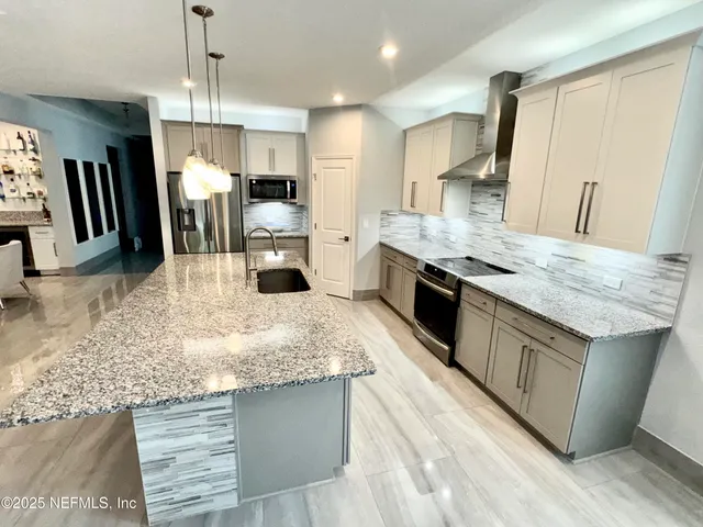 a view of kitchen with wooden floor and electronic appliances