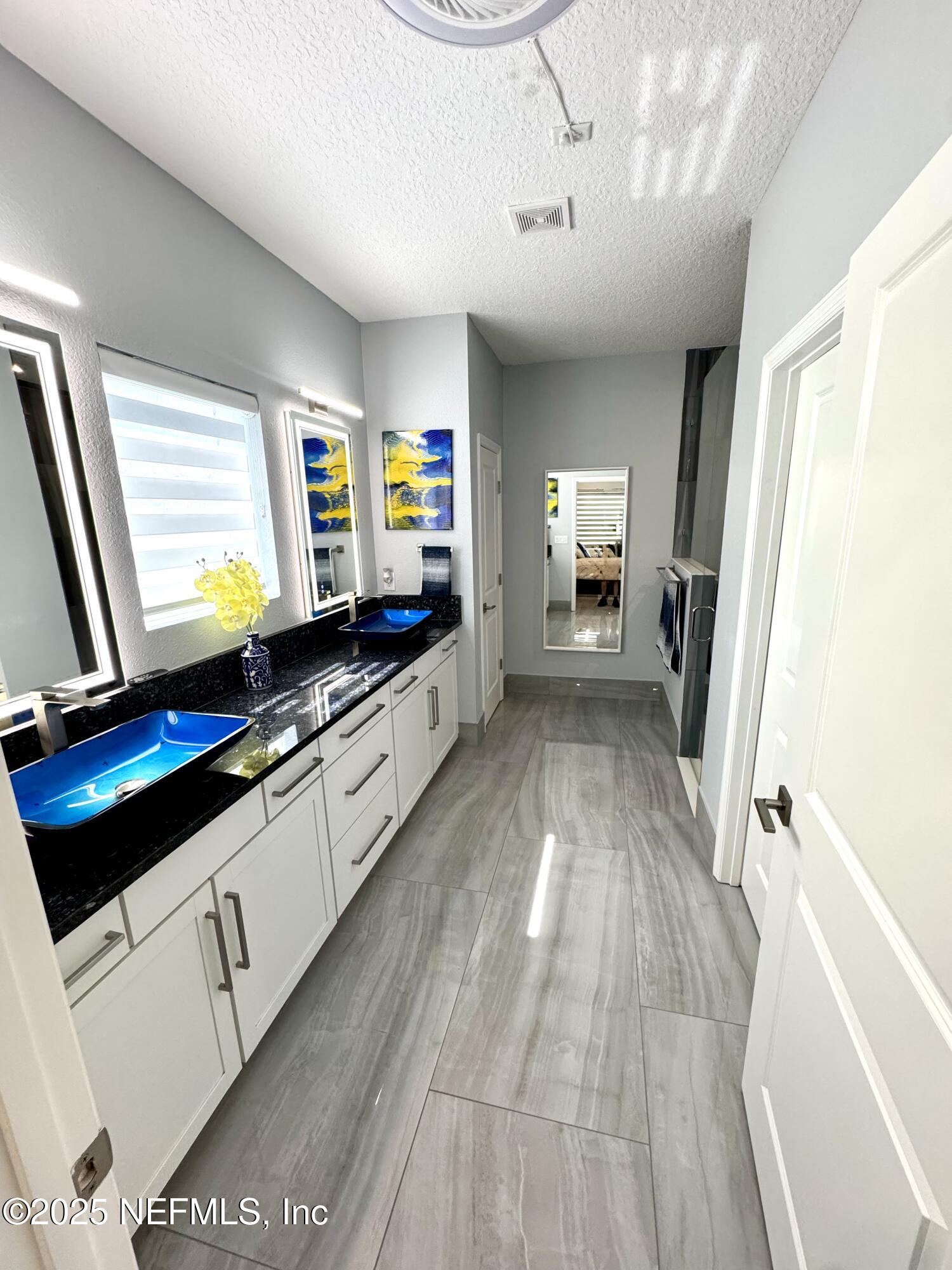 163 Pine Forest Court St. Augustine, FL 32092 - Photo 45 of 85 a kitchen with granite countertop a stove a sink and a refrigerator