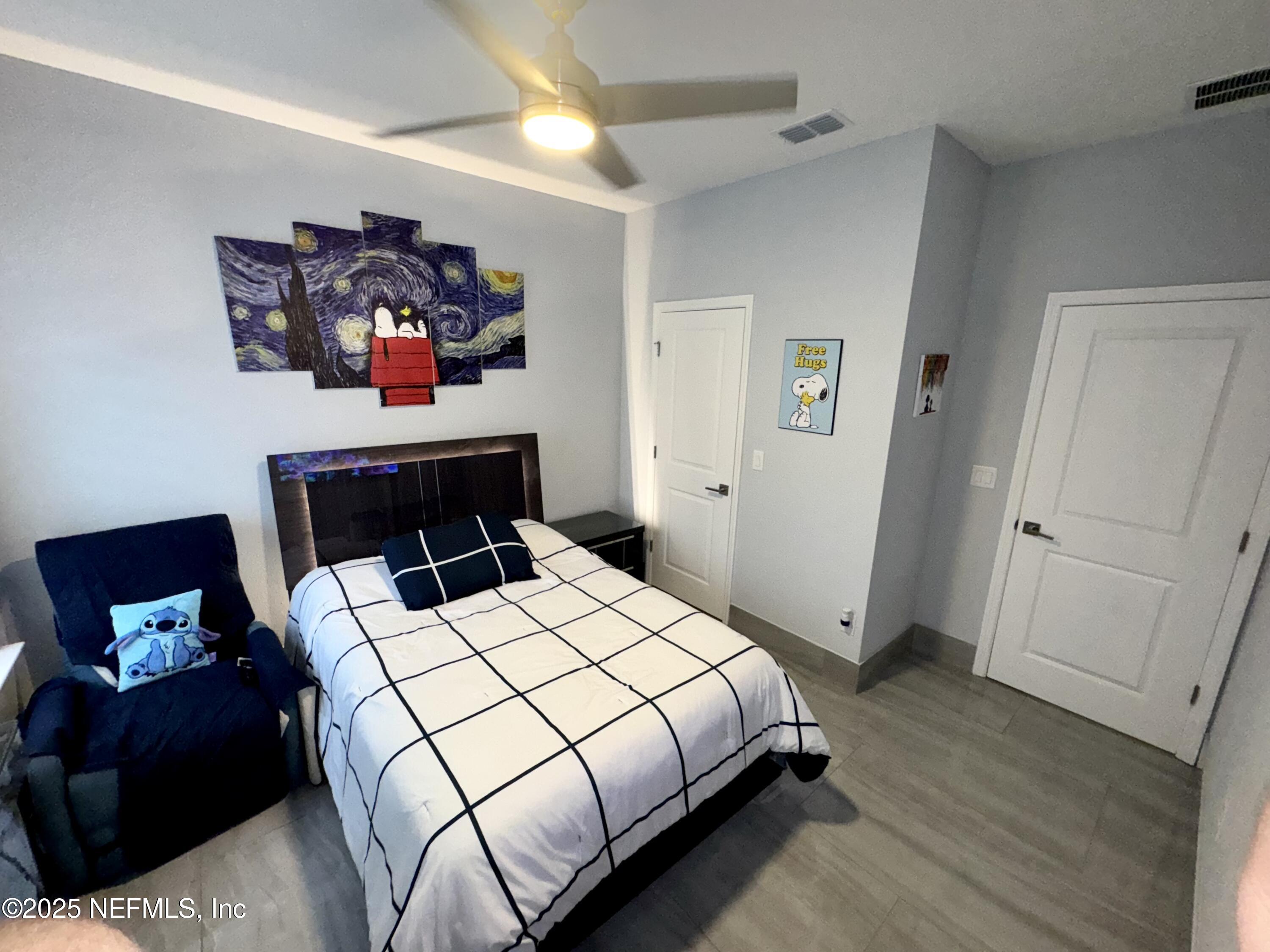 163 Pine Forest Court St. Augustine, FL 32092 - Photo 61 of 85 a bedroom with a bed and wooden floor