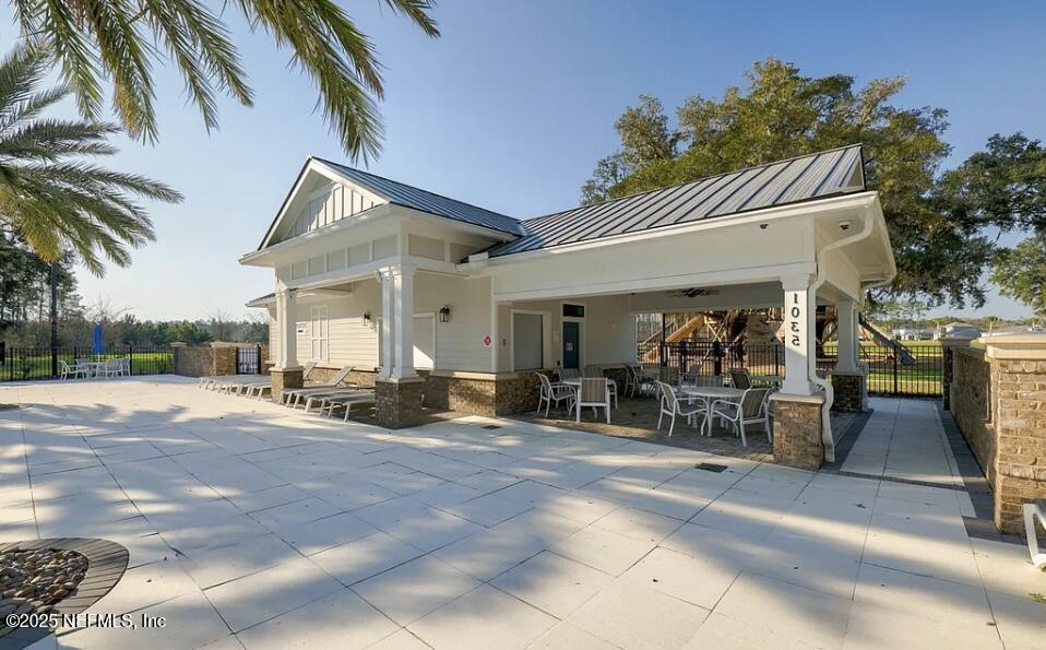 163 Pine Forest Court St. Augustine, FL 32092 - Photo 80 of 85 a view of a patio with table and chairs under an umbrella