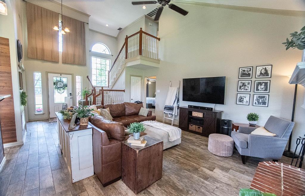 10336 Jennifer Circle Forney, TX 75126 - Photo 7 of 37 This large, open concept room features architectueal interest with its arched windows, sidelights, vaulted ceiling, and large arched transom window above the entry door.