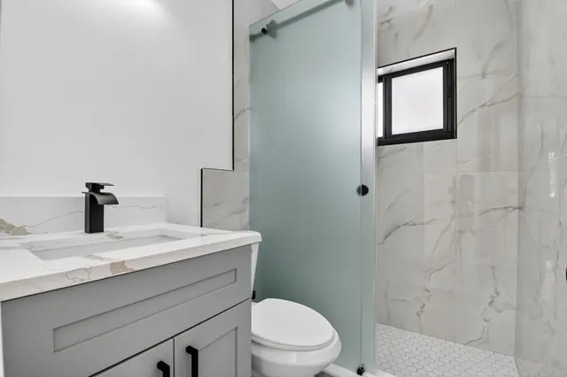 a bathroom with a sink a toilet and mirror