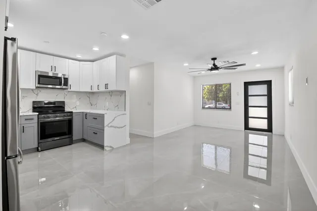 a kitchen with stainless steel appliances a refrigerator sink and cabinets