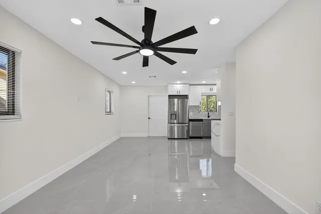 a view of a kitchen with a sink and a ceiling fan