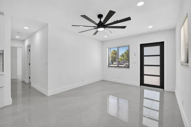 a view of an empty room with a ceiling fan