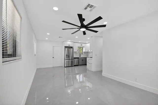 a view of a kitchen with a sink and a window