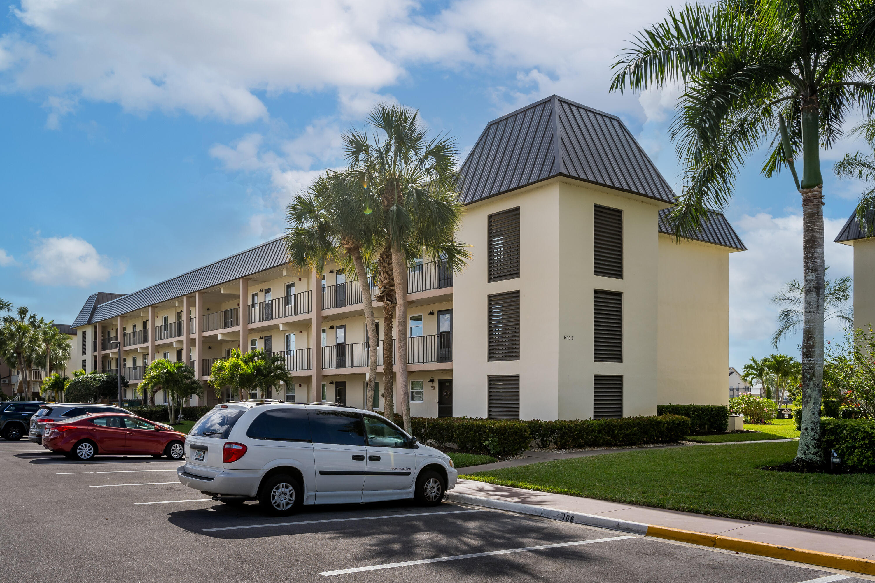 1010 Manatee Road, Unit B 305 Naples, FL 34114 - Photo 1 of 23 a view of a car parked in front of a house