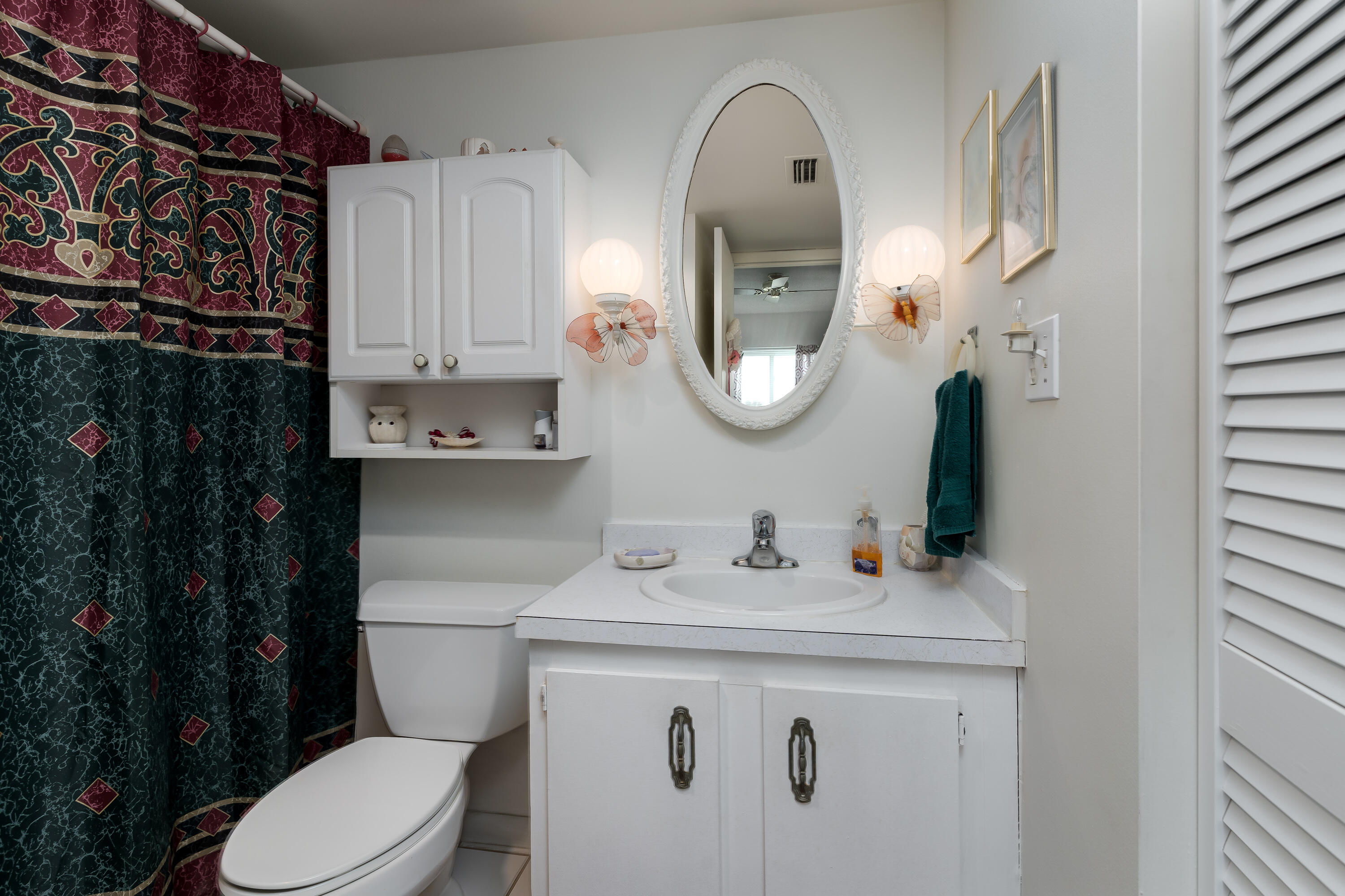 1010 Manatee Road, Unit B 305 Naples, FL 34114 - Photo 12 of 23 a bathroom with a sink a toilet and a mirror