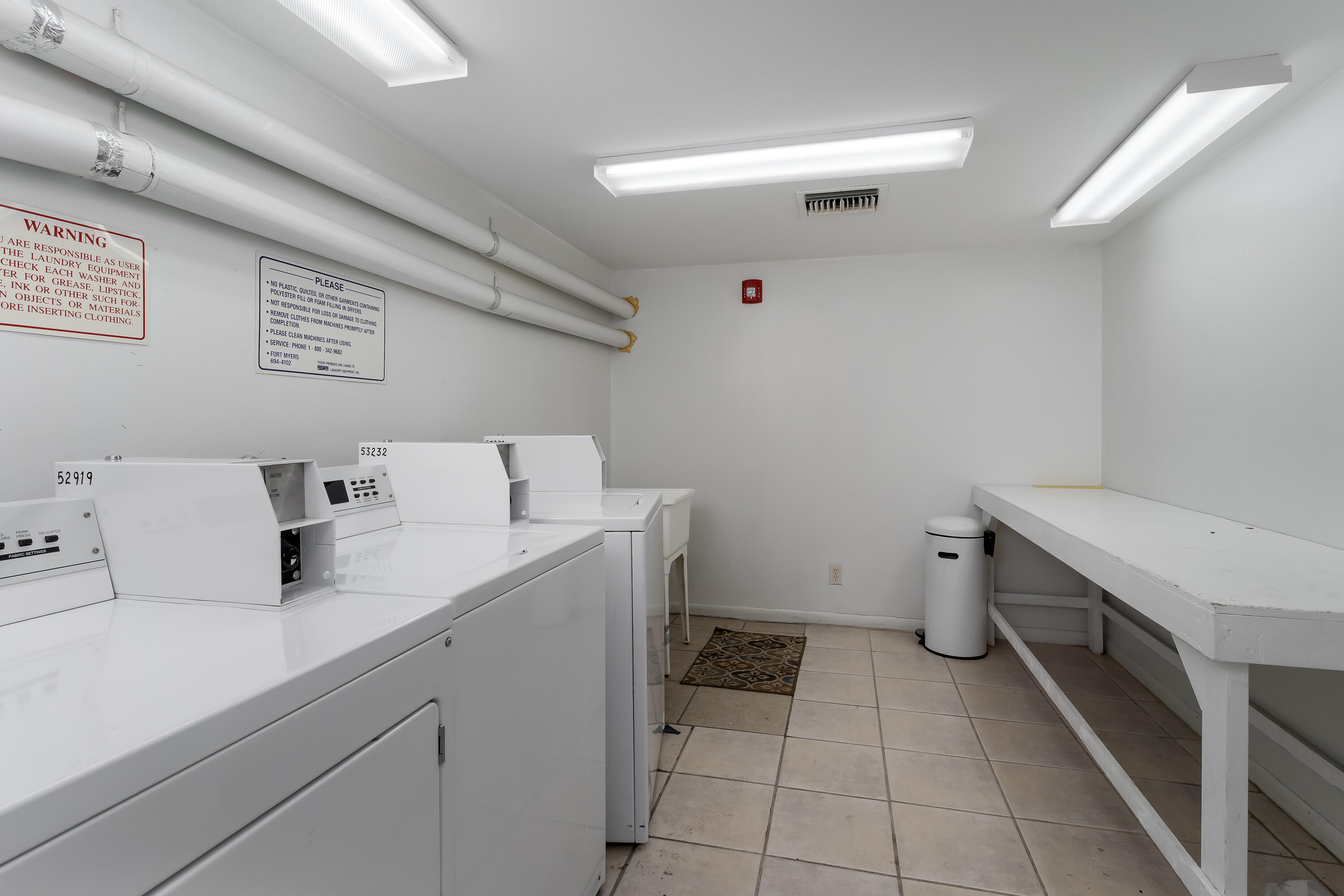 1010 Manatee Road, Unit B 305 Naples, FL 34114 - Photo 18 of 23 a utility room with a sink dryer and washer