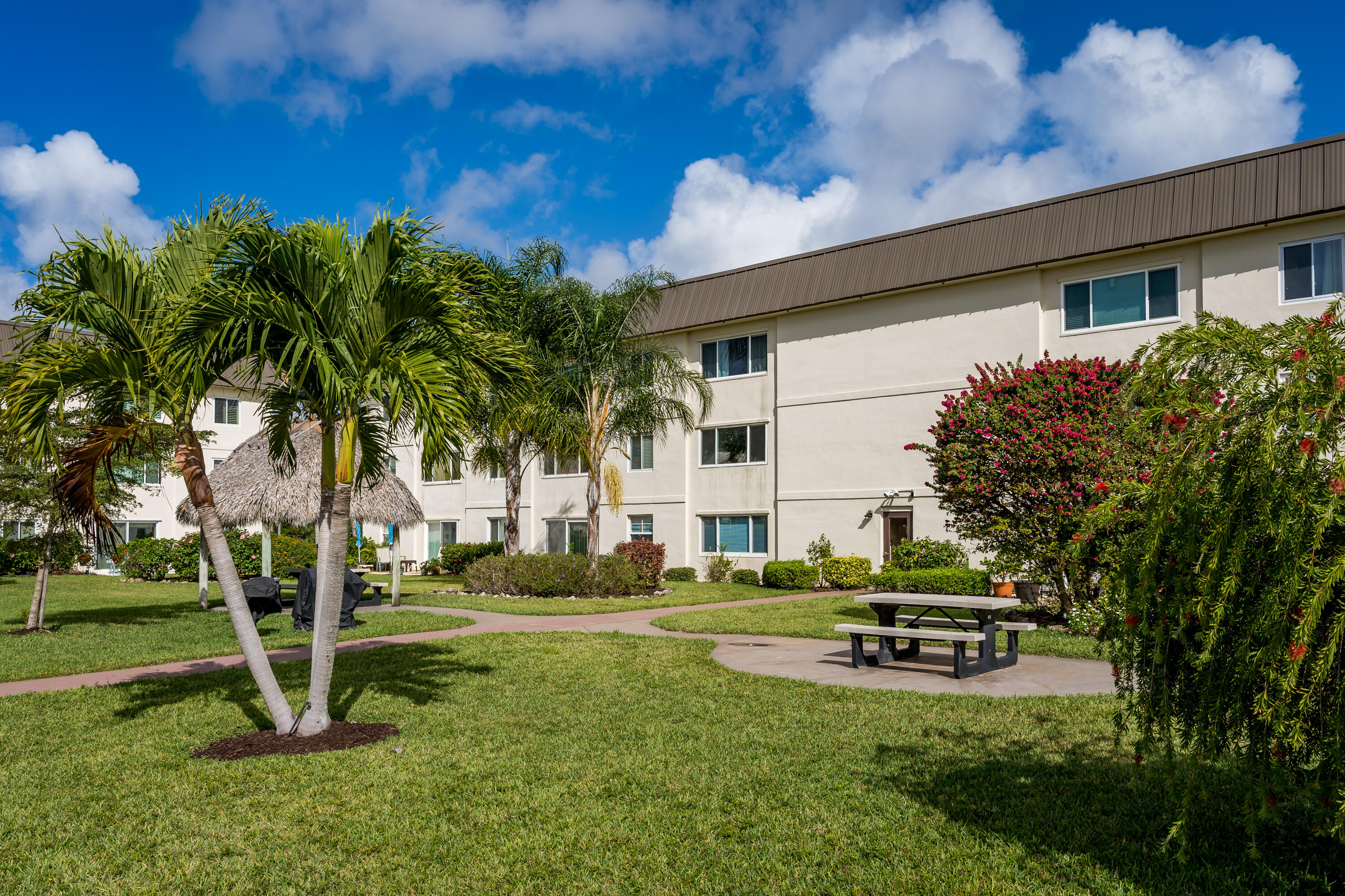 1010 Manatee Road, Unit B 305 Naples, FL 34114 - Photo 2 of 23 a house with garden in front of it