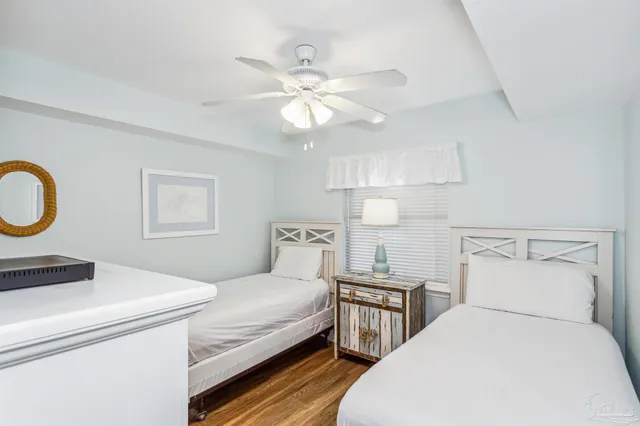 a bedroom with bed and a chandelier