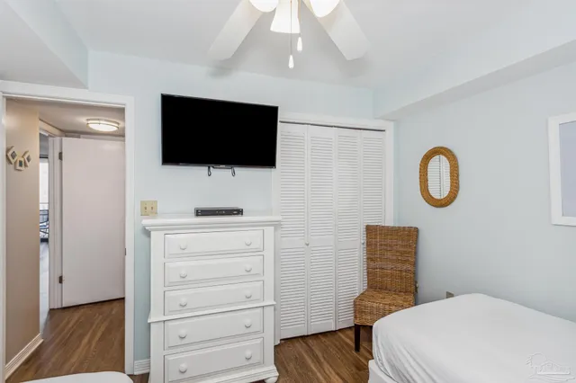 a room with a flat screen tv and a dresser