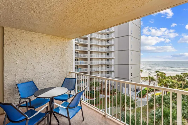 a view of a chairs and table in the balcony