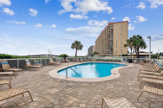 a view of swimming pool with outdoor seating and plants