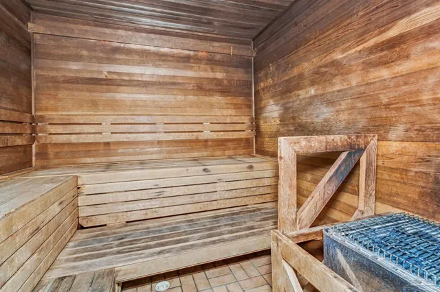 a view of swimming pool with lawn chairs and plants