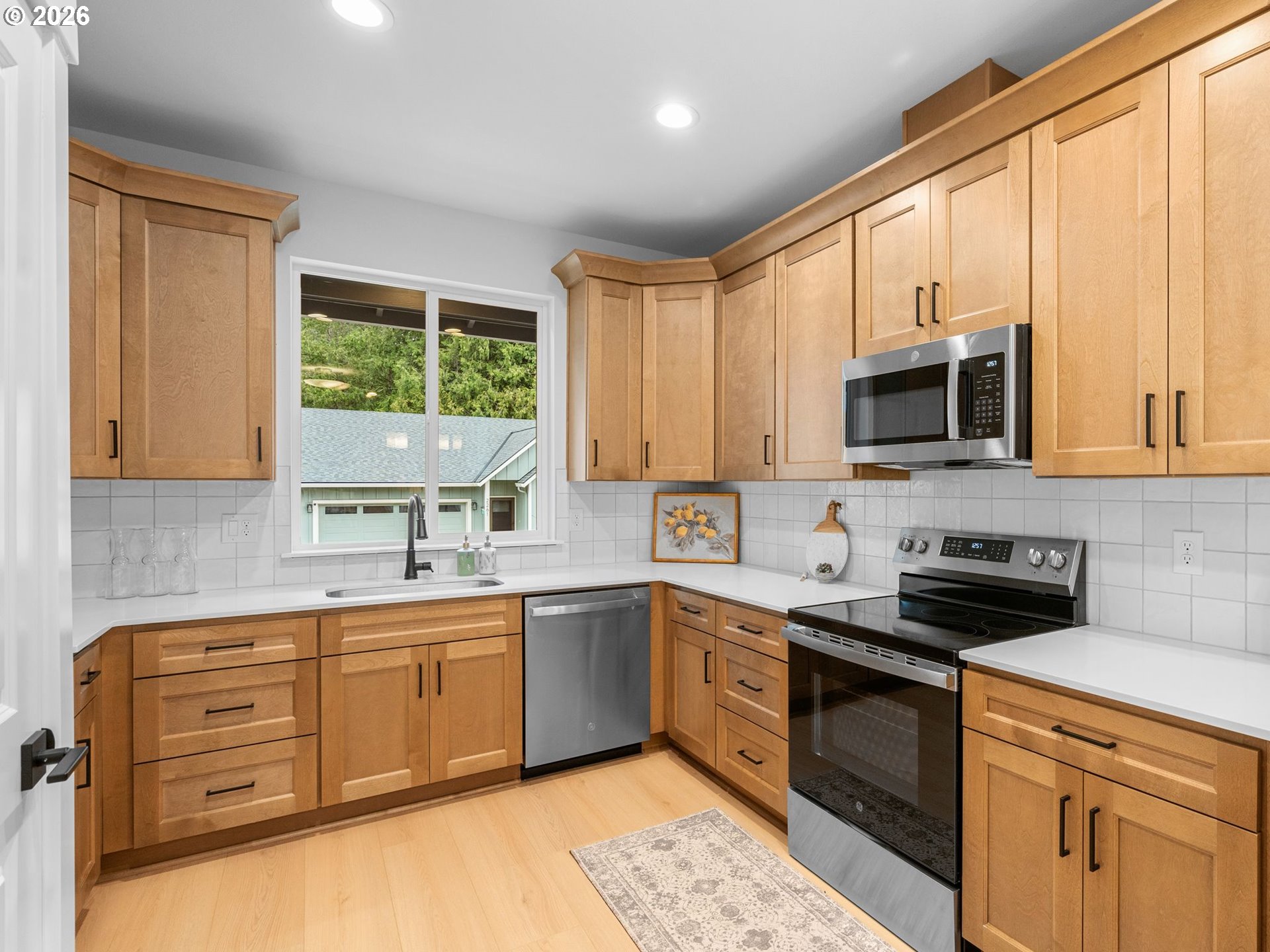 2250 Northeast 207th Place Fairview, OR 97024 - Photo 7 of 36 a kitchen with a sink stove top oven and cabinets