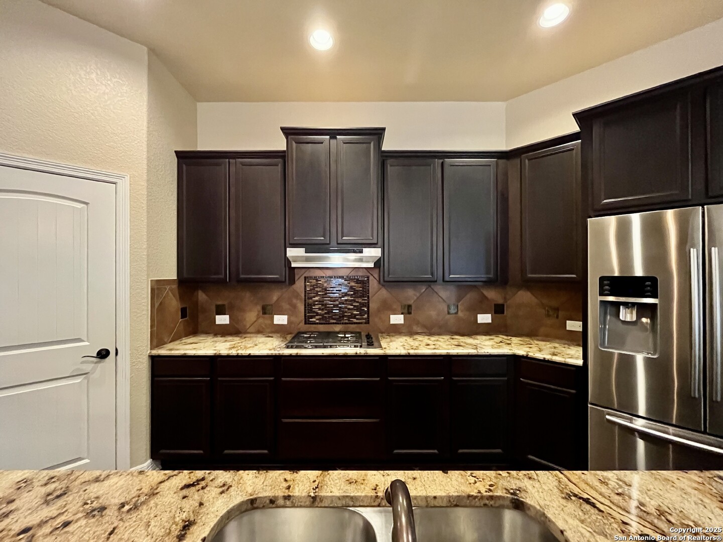 8123 Poconos Run San Antonio, TX 78255 - Photo 14 of 47 a kitchen with granite countertop wooden cabinets and stainless steel appliances