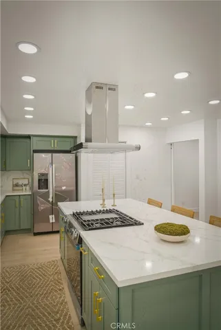 a kitchen with a sink a stove and chairs