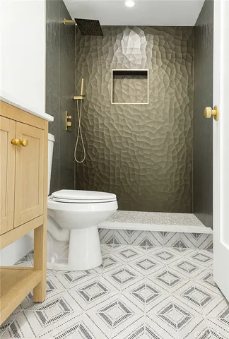 a bathroom with a toilet and a shower