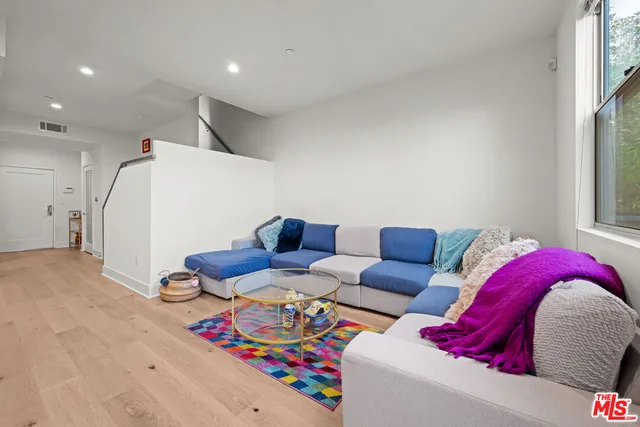 a living room with furniture and a floor to ceiling window