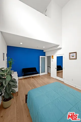 a bedroom with a bed and a couch