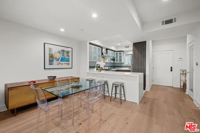 a living room with stainless steel appliances kitchen island granite countertop furniture and a kitchen view