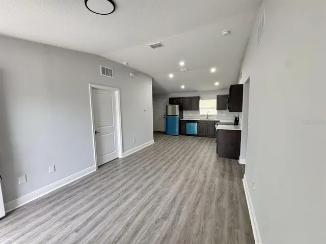 a view of kitchen and wooden floor