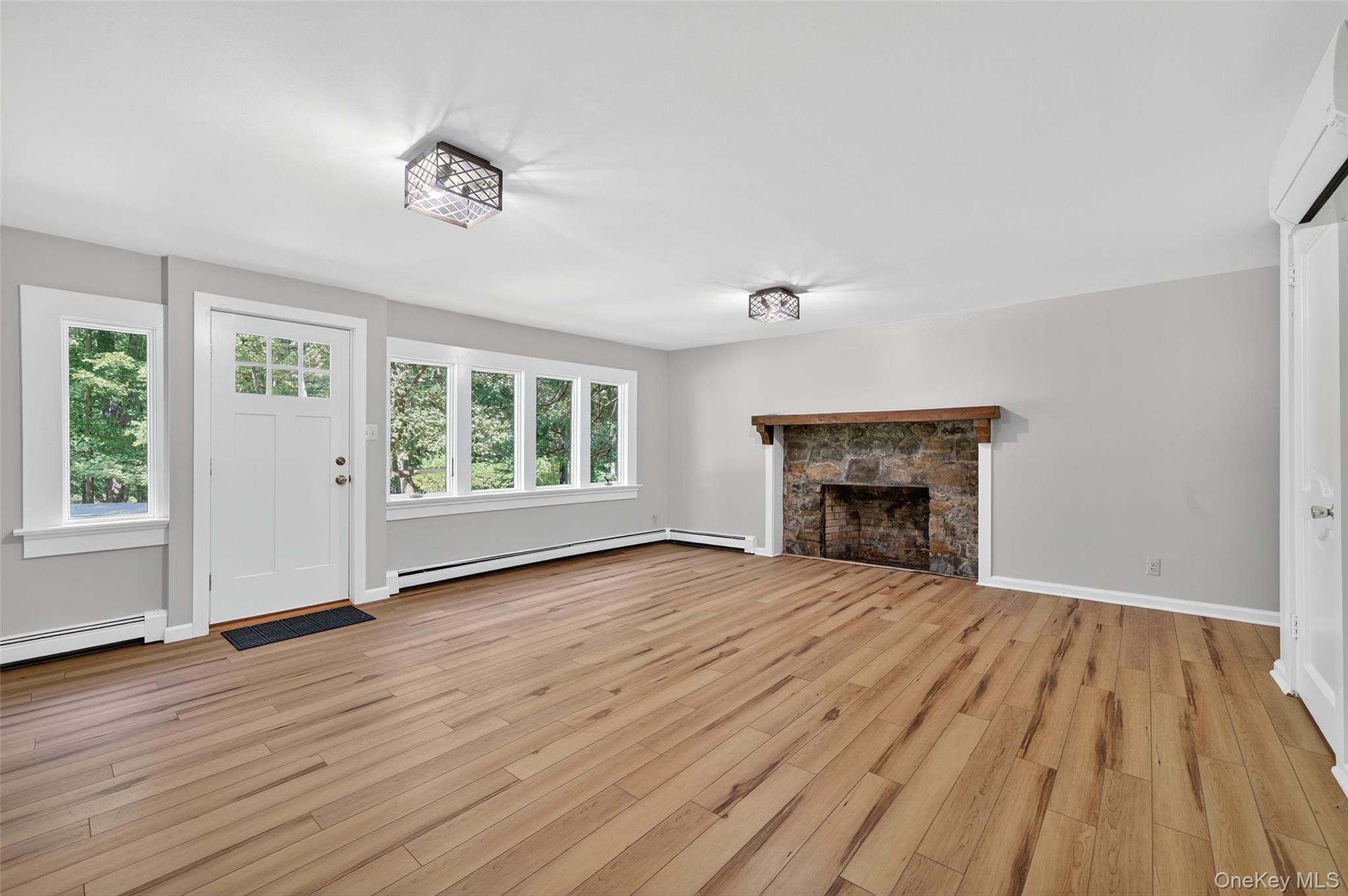 91 Sleepy Valley Road Warwick, NY 10990 - Photo 5 of 30 a view of empty room with wooden floor and fireplace