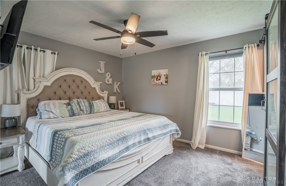1442 Langdon Road Sidney, OH 45365 - Photo 14 of 34 This inviting bedroom provides a tranquil retreat, perfect for unwinding after a long day.