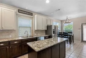 a kitchen with granite countertop sink cabinets and stainless steel appliances