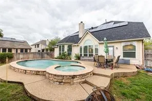 a view of a house with swimming pool and sitting area