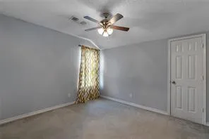 an empty room with closet and windows