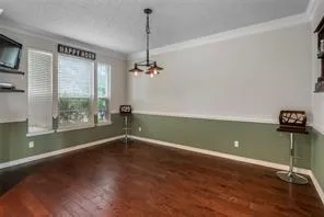 a view of room with window and wooden floor