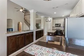 a kitchen with granite countertop a sink appliances and cabinets