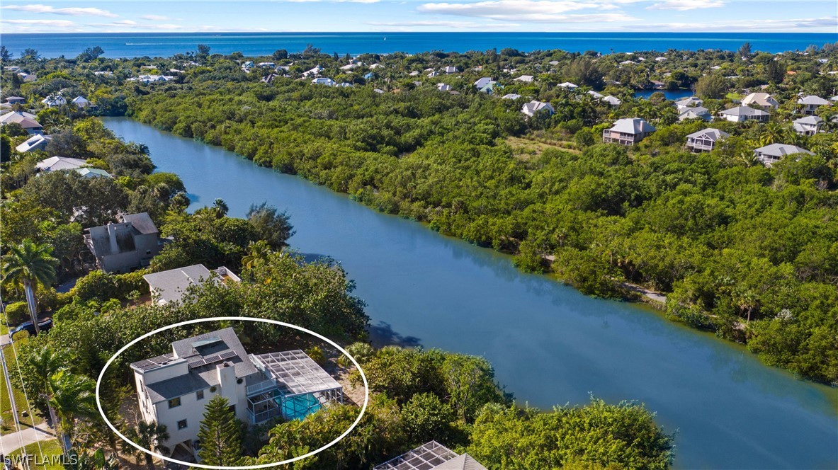 705 Rabbit Road Sanibel, FL 33957 - Photo 1 of 35 a view of a house with a yard and sitting area