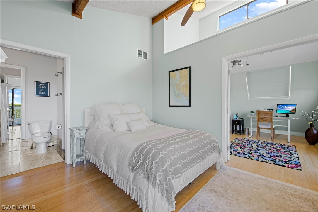 705 Rabbit Road Sanibel, FL 33957 - Photo 13 of 35 a bedroom with a bed a mirror and lamp on desk