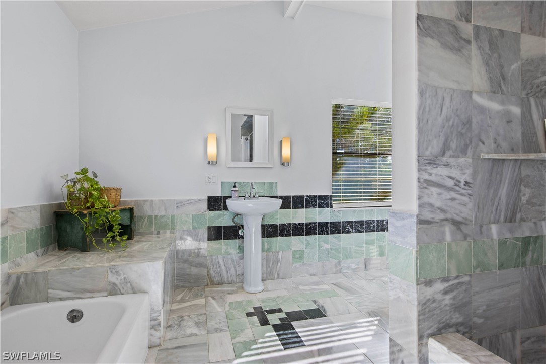 705 Rabbit Road Sanibel, FL 33957 - Photo 16 of 35 a bath room with a sink and a mirror