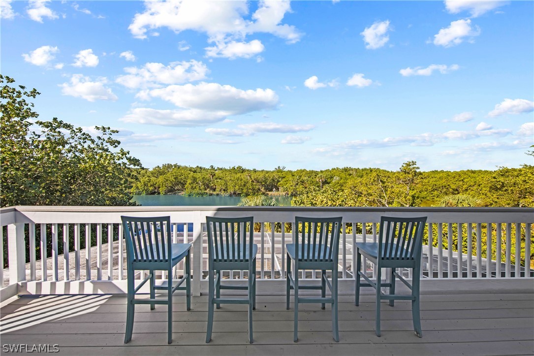 705 Rabbit Road Sanibel, FL 33957 - Photo 18 of 35 a view of a chairs and table on the terrace