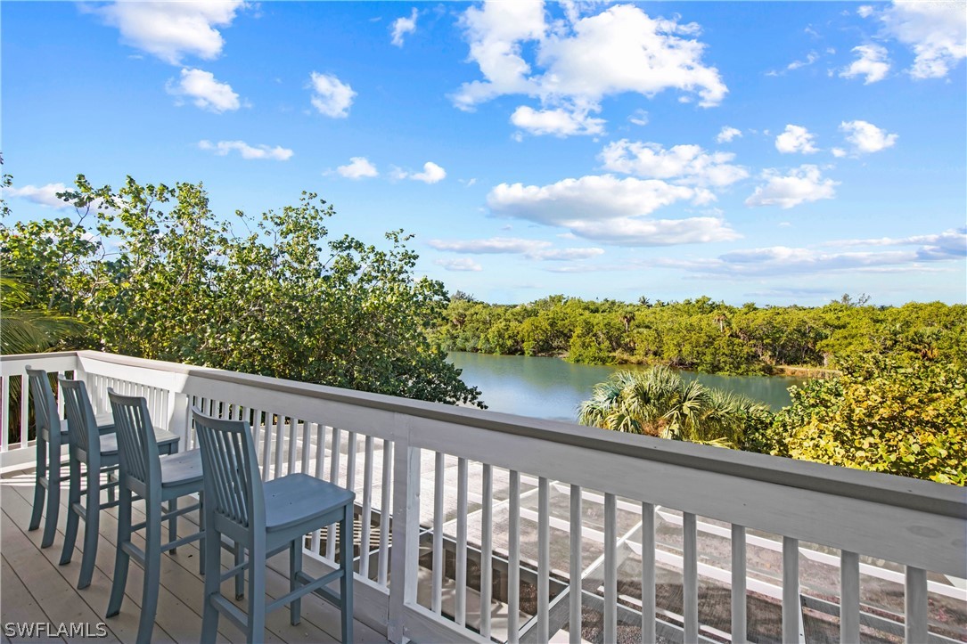 705 Rabbit Road Sanibel, FL 33957 - Photo 19 of 35 a view of a chairs and table in the balcony