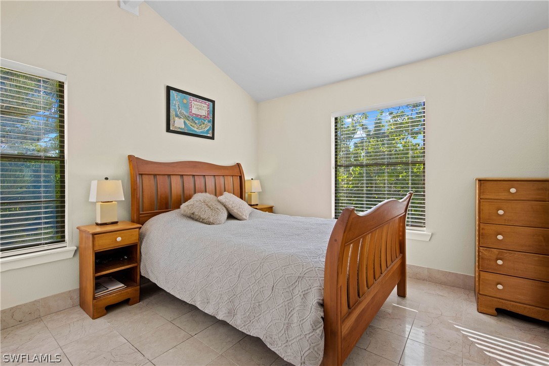 705 Rabbit Road Sanibel, FL 33957 - Photo 20 of 35 a bedroom with a bed and a window