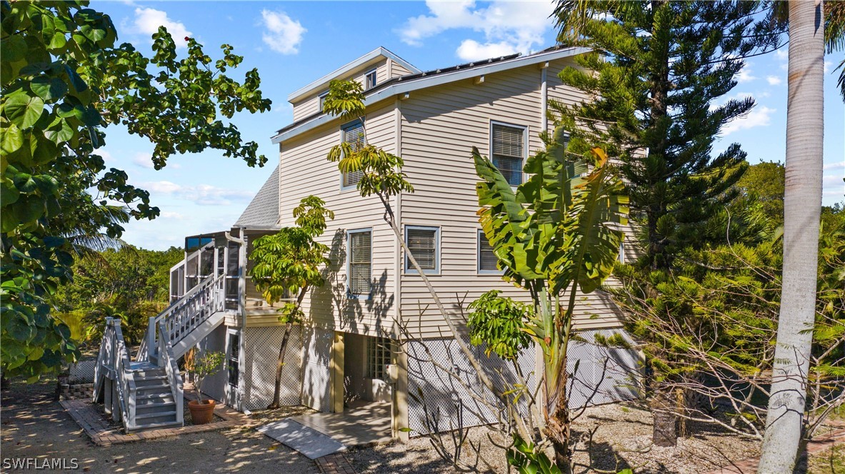 705 Rabbit Road Sanibel, FL 33957 - Photo 2 of 35 a view of a house with a tree