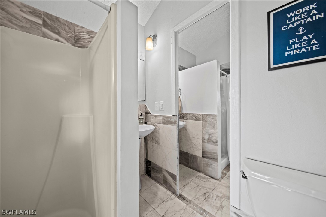 705 Rabbit Road Sanibel, FL 33957 - Photo 21 of 35 a bathroom with a shower and a sink