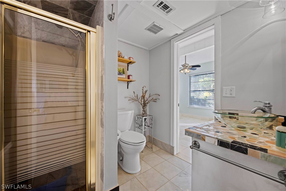 705 Rabbit Road Sanibel, FL 33957 - Photo 23 of 35 a bathroom with a granite countertop sink and a toilet