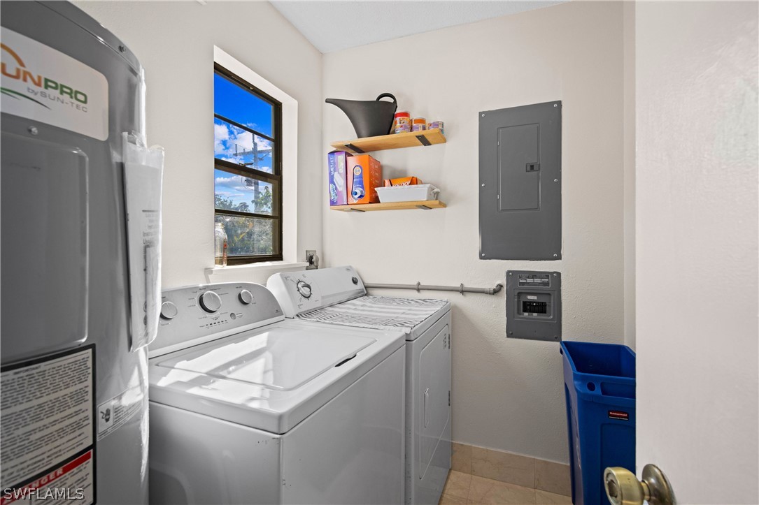 705 Rabbit Road Sanibel, FL 33957 - Photo 25 of 35 a utility room with dryer washer and a fridge