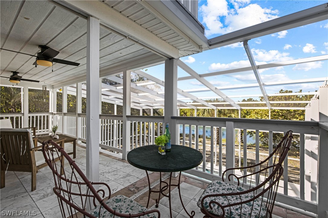 705 Rabbit Road Sanibel, FL 33957 - Photo 28 of 35 a view of a chairs and table in the balcony