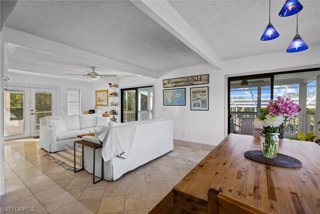 705 Rabbit Road Sanibel, FL 33957 - Photo 3 of 35 a living room with furniture potted plant and a flat screen tv